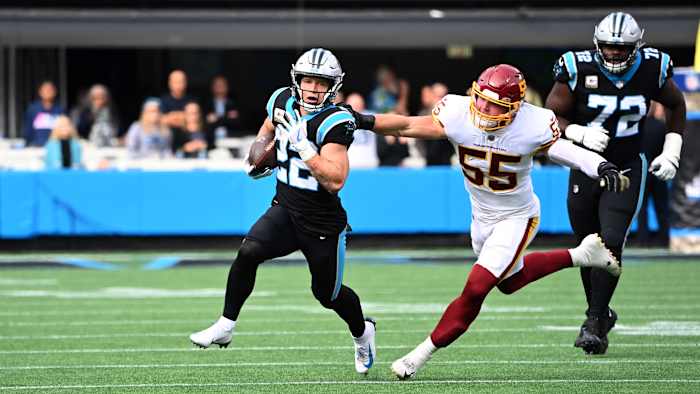 Carolina Panthers running back Christian McCaffrey (22) with the ball as Washington Football Team outside linebacker Cole Holcomb (55) defends in the first quarter at Bank of America Stadium.